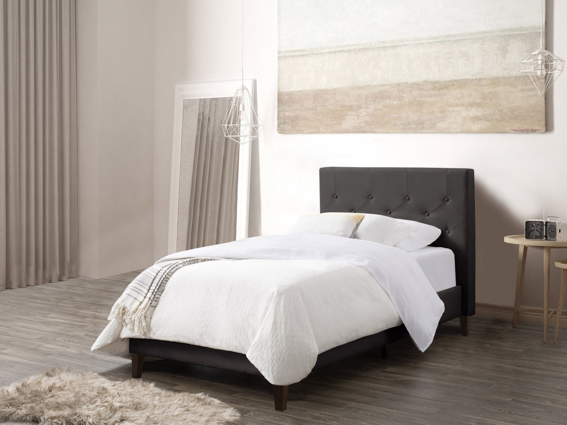 Dark grey button-tufted twin bed with upholstered headboard, sleek wooden legs, and a modern design, perfect for stylish and comfortable bedroom decor.