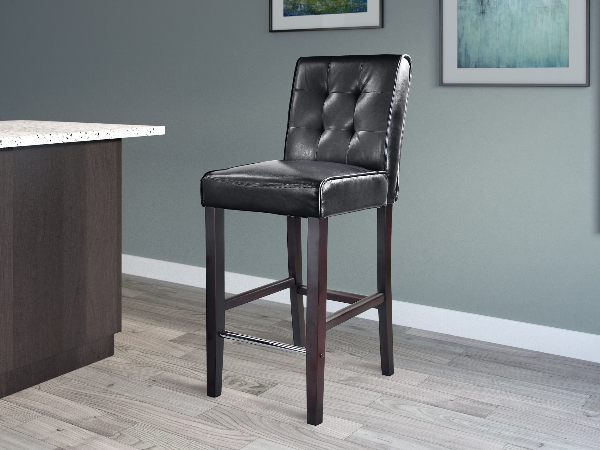 Black bar height stool with cushioned leather seat, sleek metal frame, and footrest. Ideal for modern kitchens and home bars.