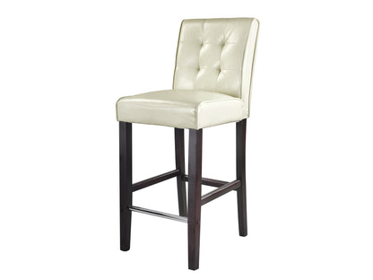 Cream bar height bar stool with padded seat, wooden legs, and a footrest. Upholstered in smooth cream fabric, featuring a modern design suitable for kitchen islands and home bars.