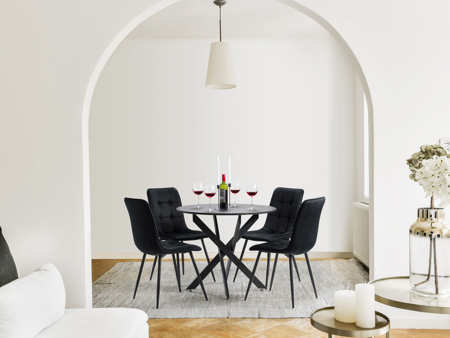 Black dining room set with a rectangular glass table and four cushioned chairs, featuring sleek black metal frames and modern design, perfect for contemporary dining spaces.