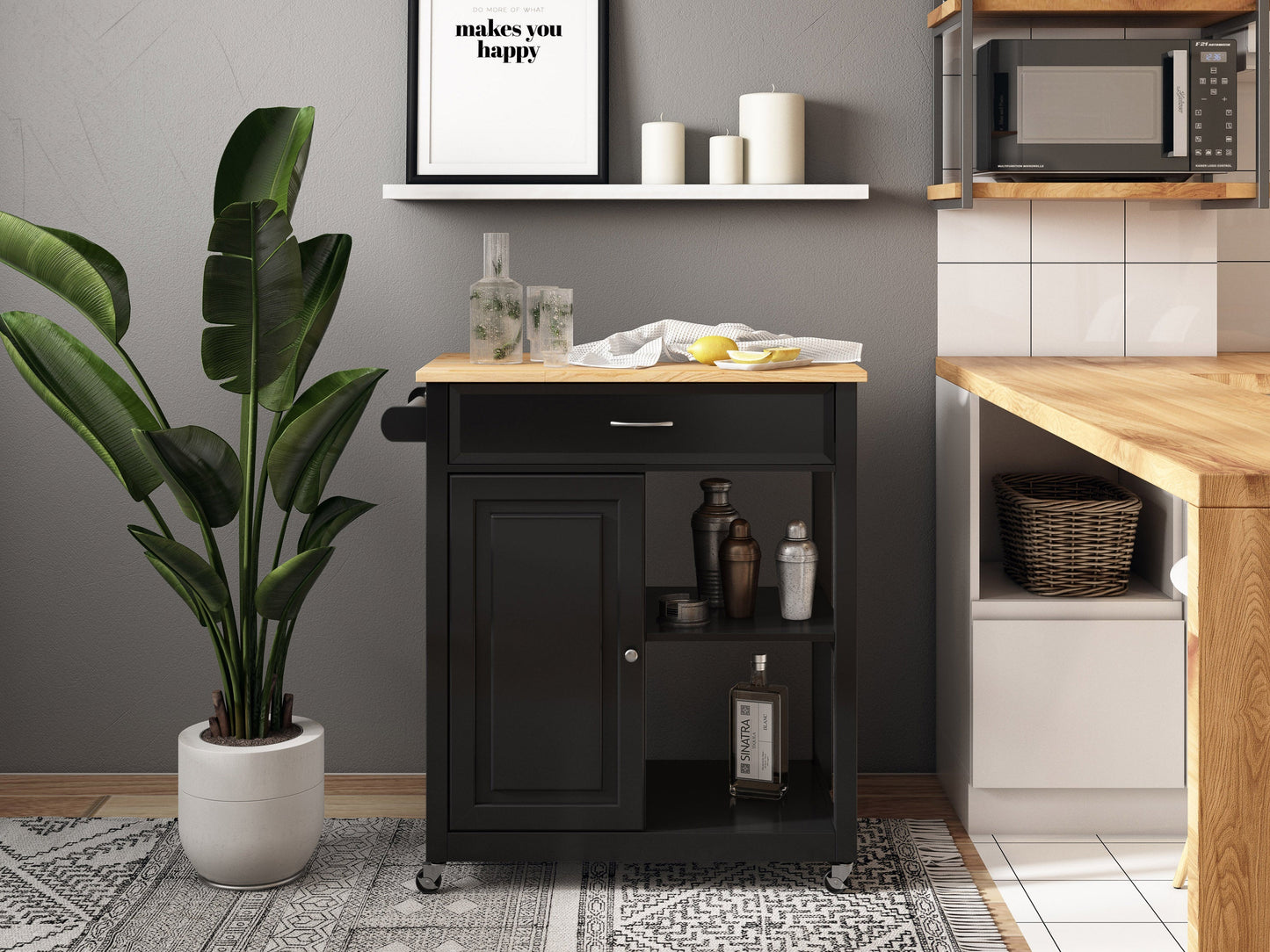 Black kitchen cart on wheels with two shelves, a drawer, and a towel rack. Made of sturdy wood with a sleek black finish. Ideal for extra storage and mobility in the kitchen.