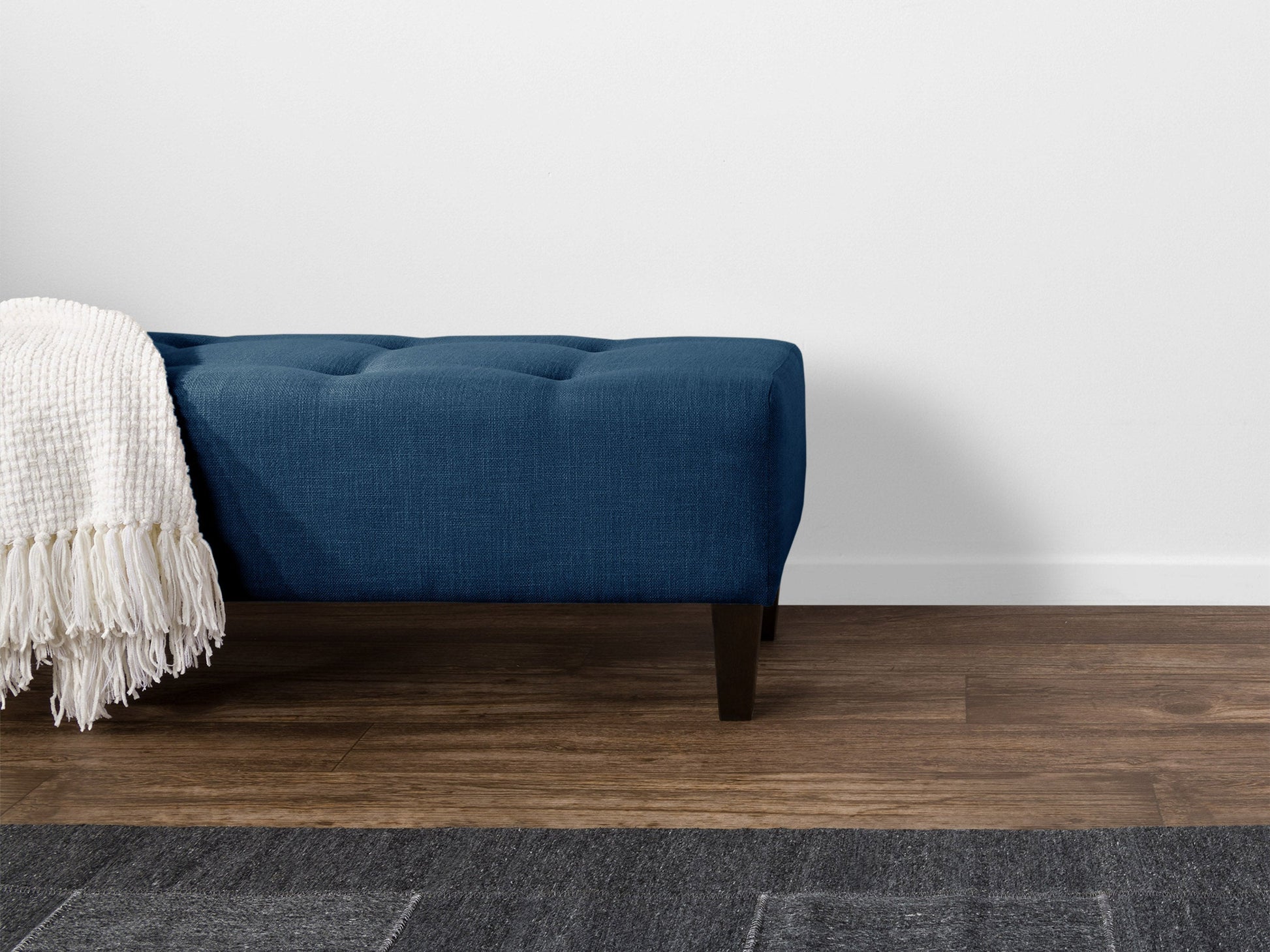 Navy blue accent bench with tufted velvet upholstery, gold metal legs, and a sleek modern design. Perfect for living rooms or entryways, providing both style and comfort.