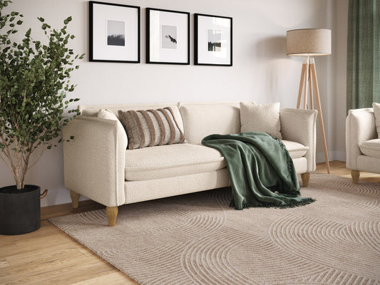 Cream Boucle Sofa with curved back, plush texture, and wooden legs. Ideal for modern living rooms. Comfortable seating with soft, tactile fabric.