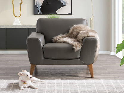 Grey faux leather armchair with sleek, modern design, featuring plush cushioning, smooth texture, and sturdy metal legs. Ideal for contemporary living rooms or offices seeking stylish, comfortable seating.