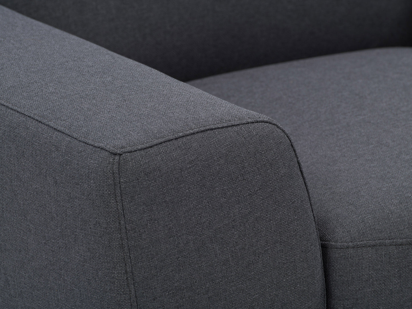 Dark grey arm chair with plush cushions, wooden legs, and a modern design; perfect for living room or office decor.