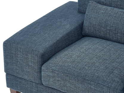 Wide blue armchair with plush cushions, wide armrests, and wooden legs. Upholstered in soft, textured fabric, perfect for living rooms or reading nooks.