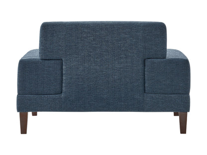 Wide blue armchair with plush cushions, wide armrests, and wooden legs. Upholstered in soft, textured fabric, perfect for living rooms or reading nooks.