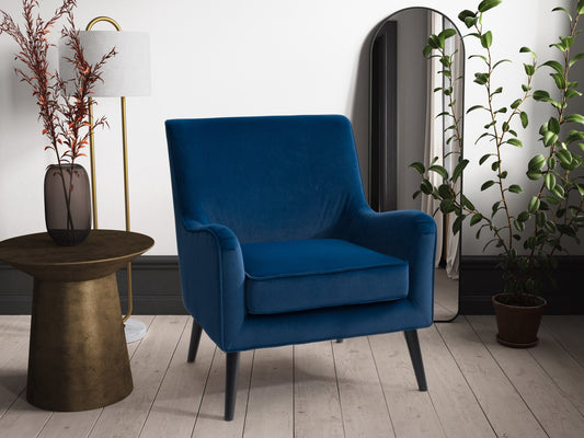 Luxurious blue velvet accent chair with tufted backrest, sleek gold legs, and plush cushioning, perfect for modern living rooms or stylish office spaces.