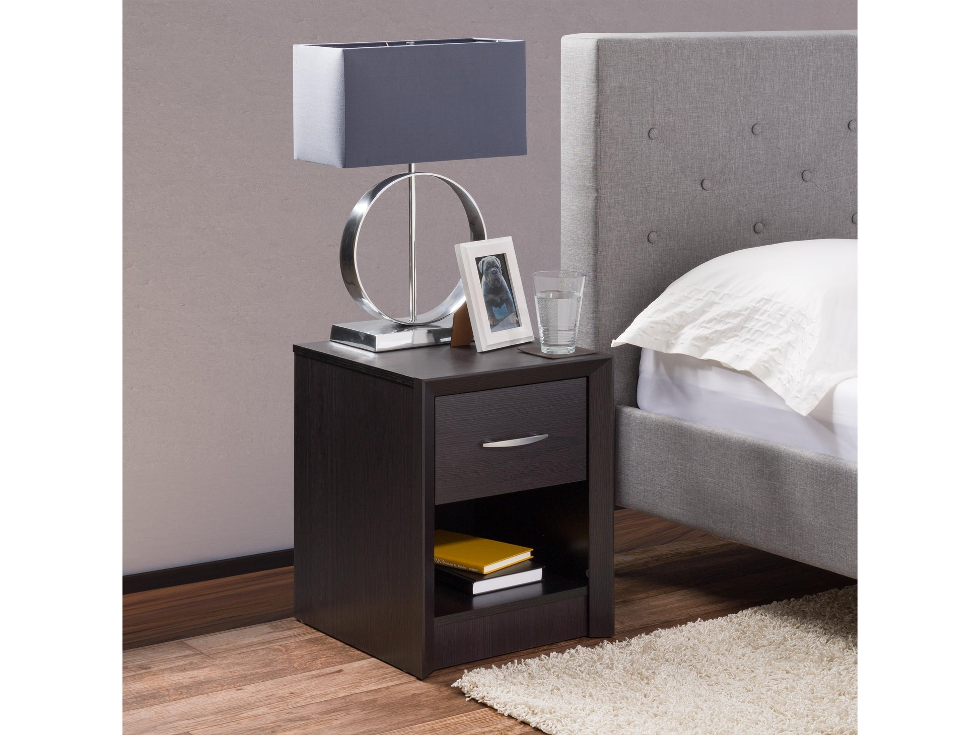 Black mid-century modern nightstand with sleek lines, wooden legs, and two spacious drawers featuring minimalist handles.