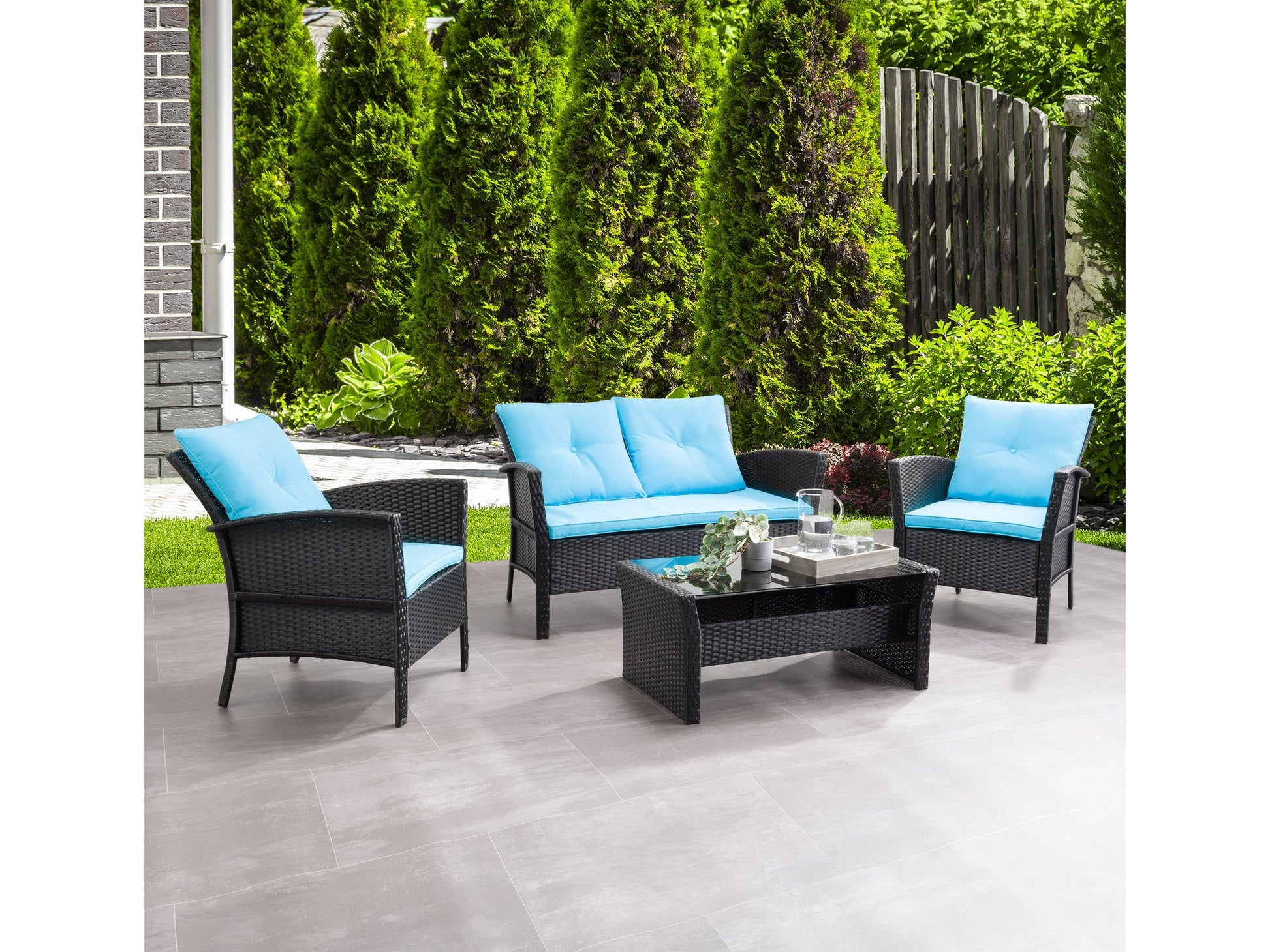 Black wicker patio conversation set with turquoise cushions, includes a loveseat, two armchairs, and a coffee table with a glass top. Durable weather-resistant materials and modern design perfect for outdoor spaces.