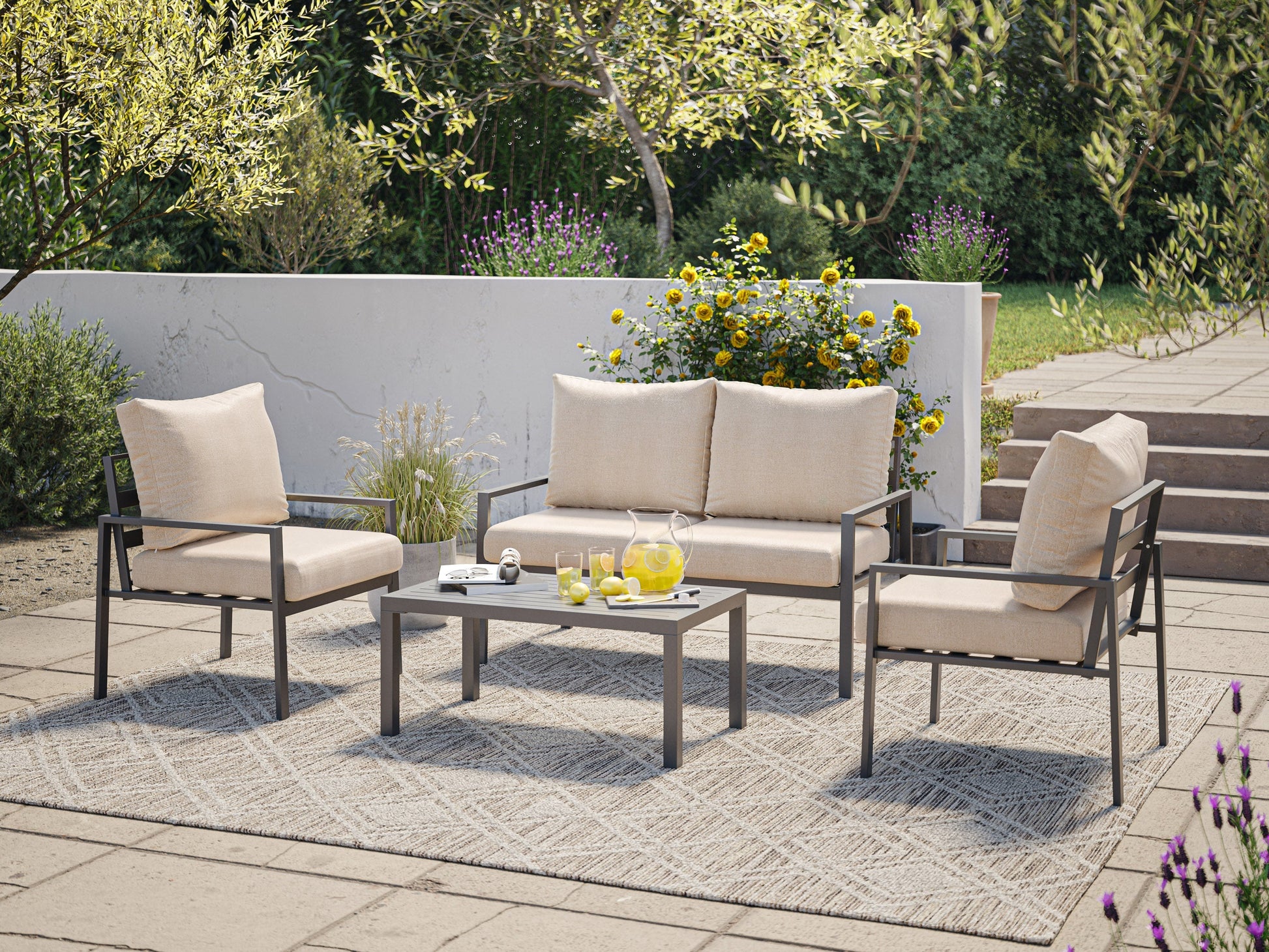 Deluxe 4-piece patio conversation set with beige cushions, dark brown wicker frame, and glass coffee table. Features include weather-resistant material and comfortable seating for outdoor relaxation.