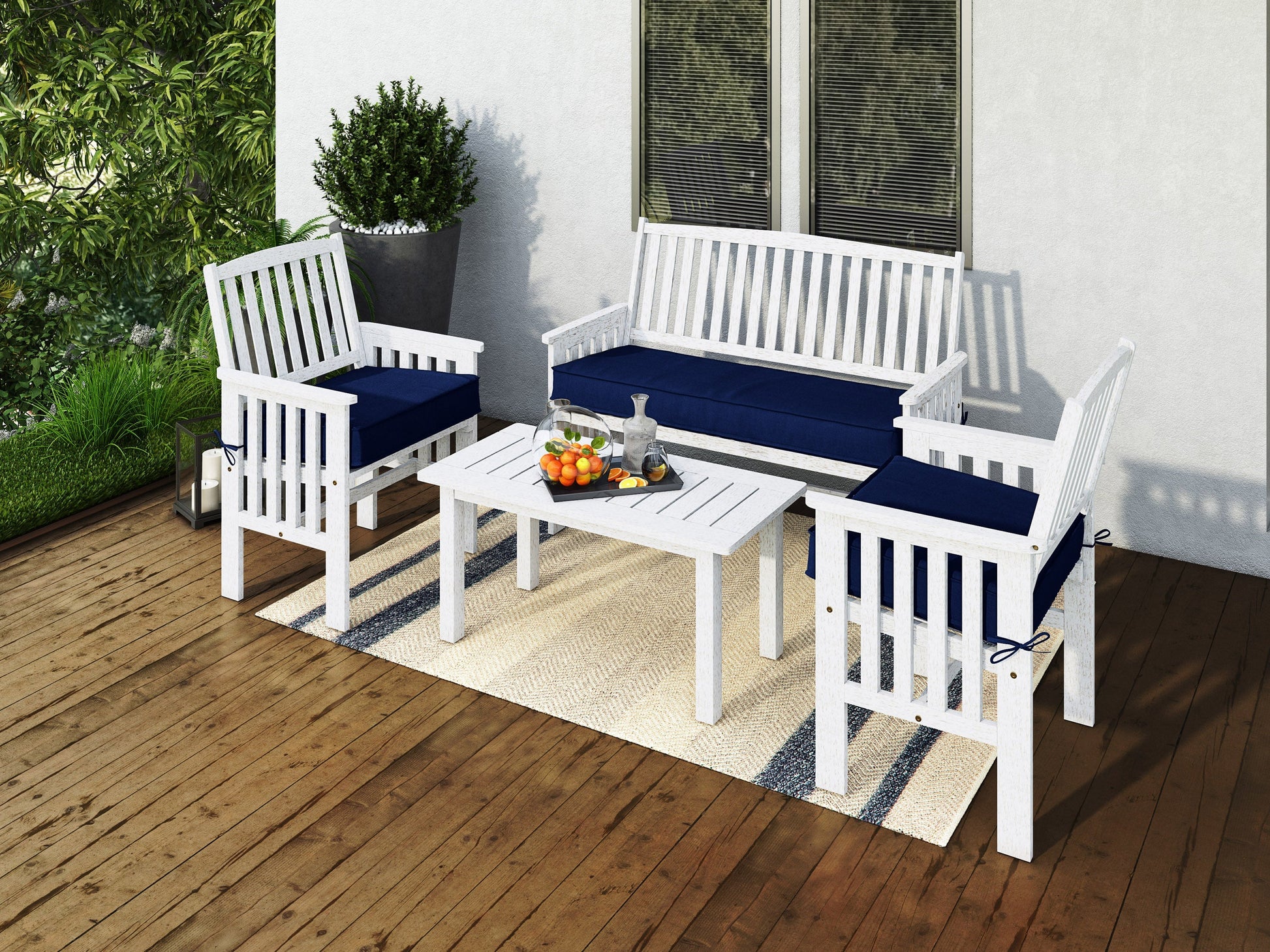 Washed white wooden patio conversation set includes a loveseat, two armchairs with beige cushions, and a rectangular coffee table. Features a rustic finish, slatted backs, and weather-resistant materials for outdoor use.