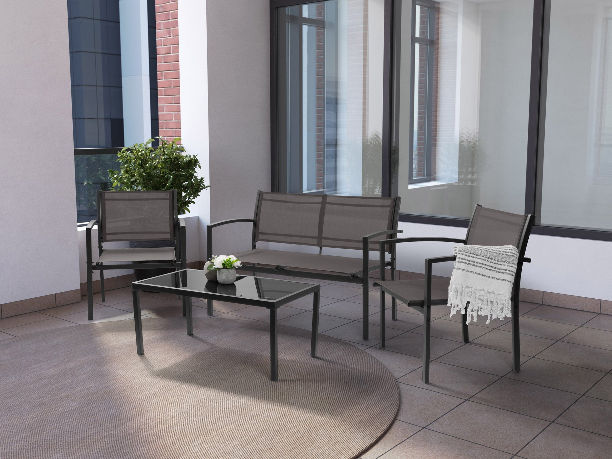 Grey metal outdoor conversation set with four pieces, including a loveseat, two chairs, and a coffee table. Features weather-resistant cushions and sleek, modern design ideal for patio or garden use.