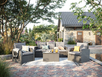 Grey outdoor patio conversation set with six pieces, including a modern sofa, two armchairs, a coffee table, and two ottomans. Features weather-resistant wicker, plush grey cushions, and a sleek tempered glass tabletop.