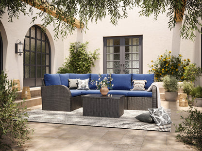 Outdoor wicker sectional set with blue cushions, 6-piece patio furniture including sofa sections and a coffee table, featuring durable rattan material, weather-resistant fabric, and modern design for outdoor living spaces.