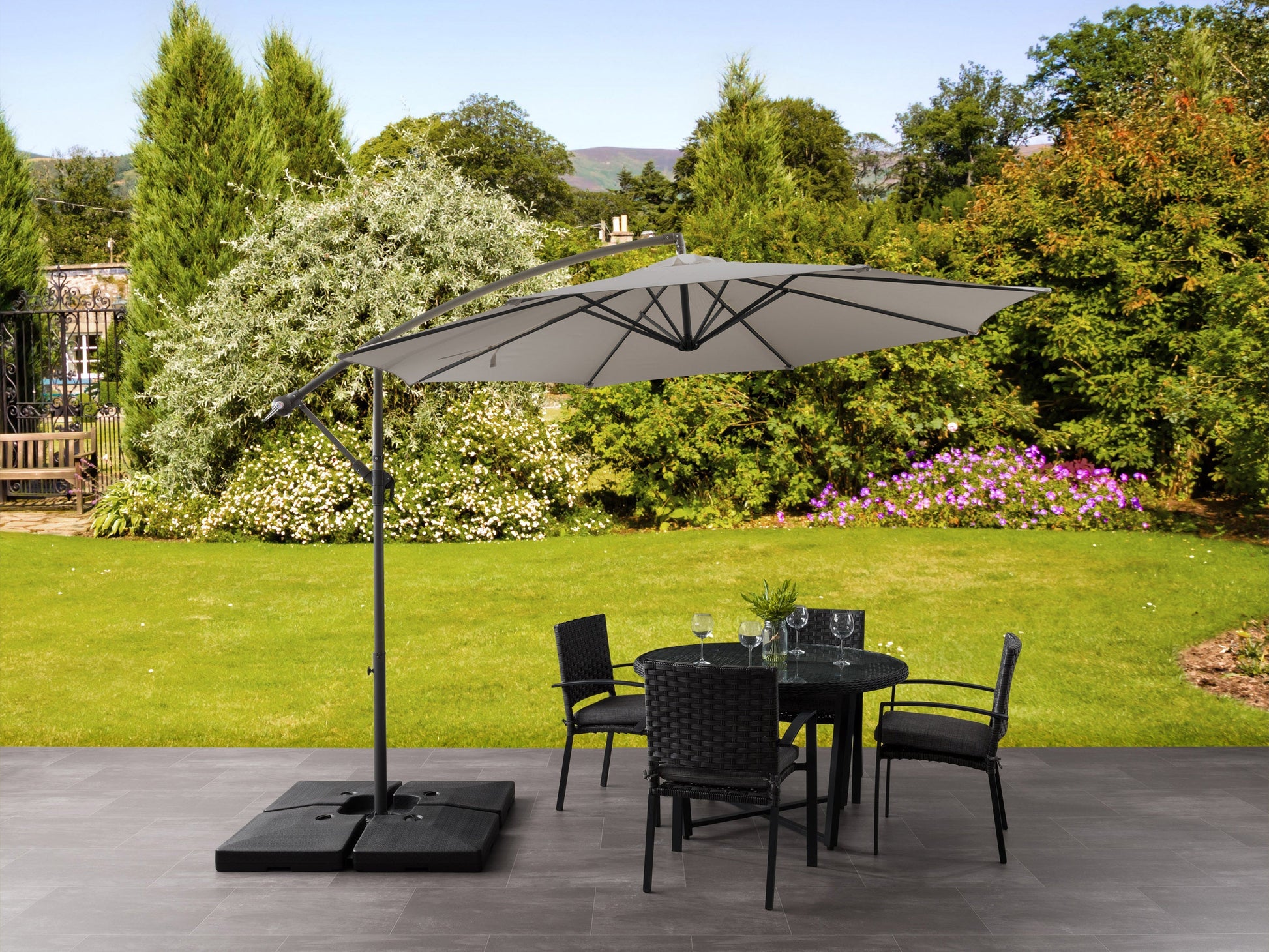 Grey 9.5ft tilting offset patio umbrella with sturdy aluminum frame, UV-resistant polyester canopy, and crank lift system for easy adjustment, perfect for outdoor shading on patios, decks, and gardens.