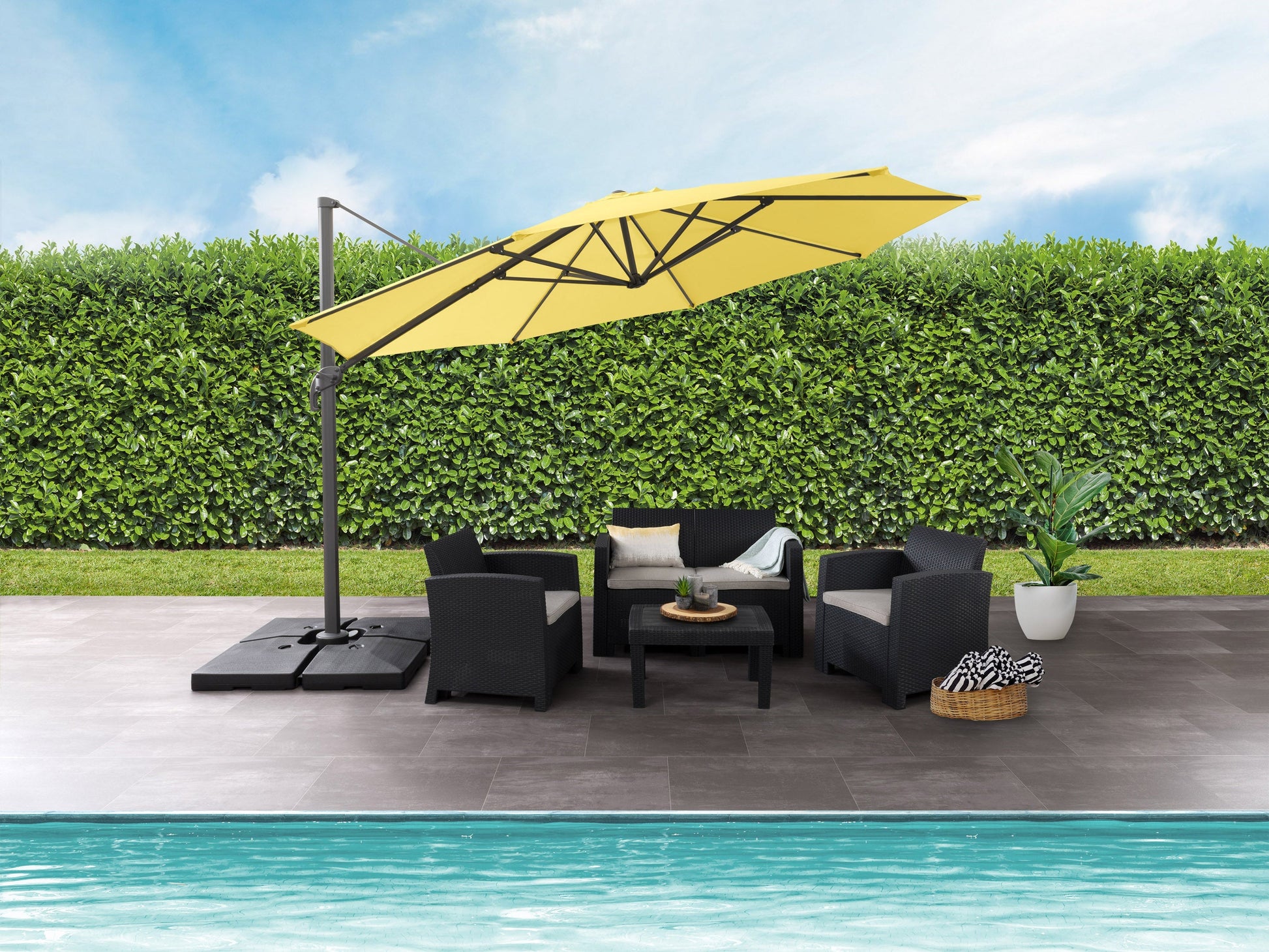 Yellow 11.5ft deluxe offset patio umbrella with a sturdy black metal frame, adjustable canopy, and wind-resistant design, providing ample shade for outdoor seating areas.