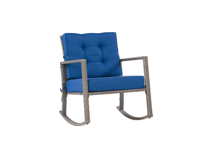 Grey wicker outdoor rocking chair with blue cushions, featuring a sturdy frame, comfortable armrests, and weather-resistant materials, perfect for patio or garden seating.