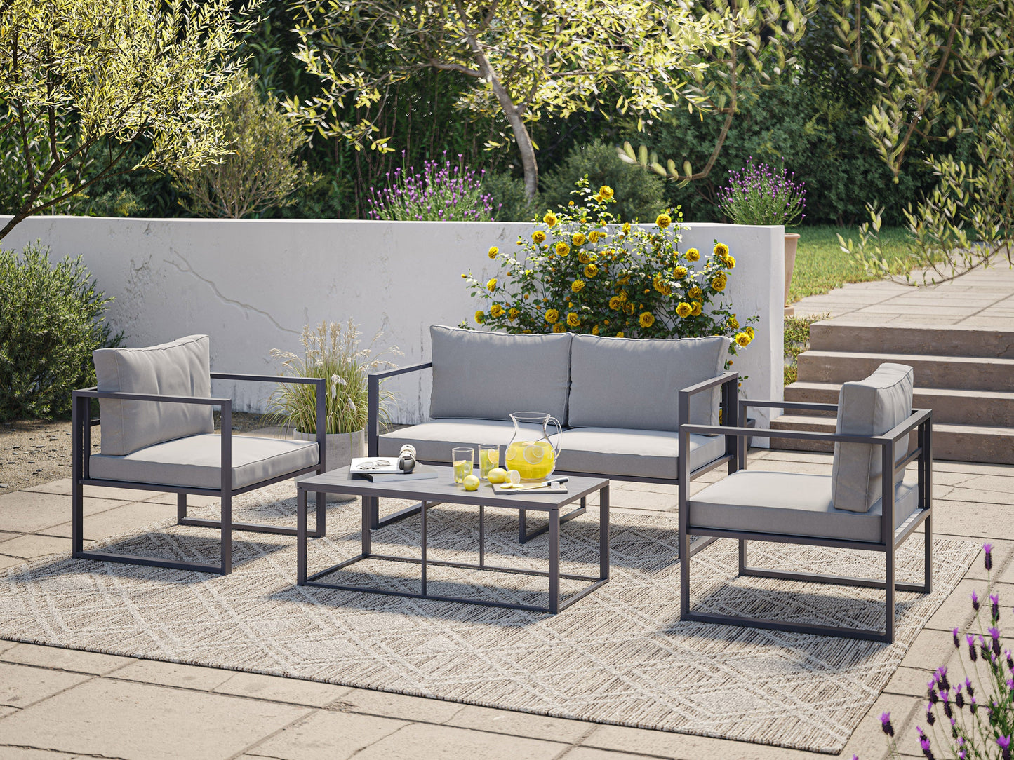 4-piece grey patio conversation set with cushioned seats, glass-top coffee table, and wicker frame. Modern outdoor furniture featuring weather-resistant materials, perfect for garden, deck, or backyard lounging.