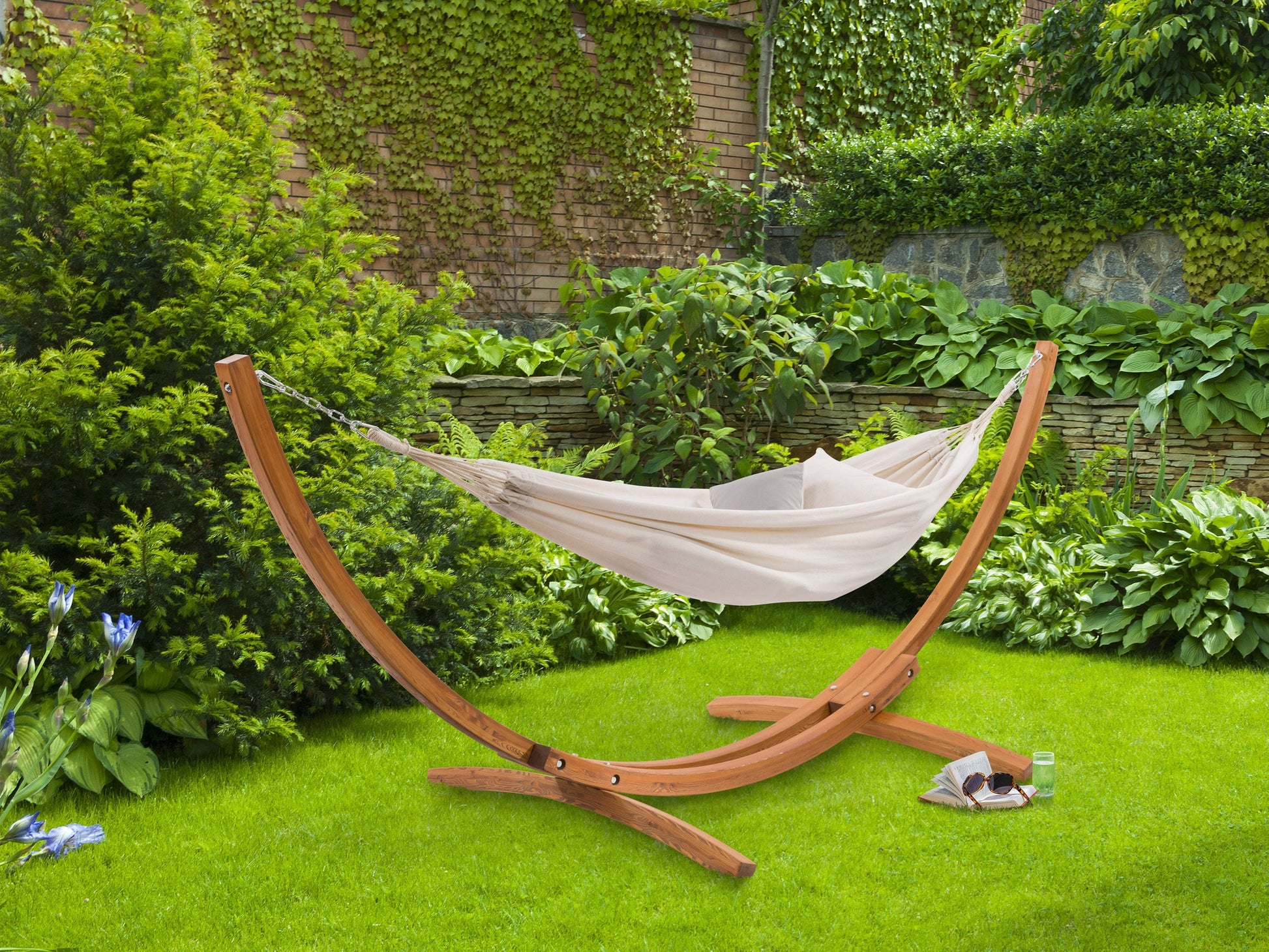 Beige patio hammock with wooden stand, featuring a durable cotton fabric, curved wooden frame, and sturdy metal chains for outdoor relaxation. Ideal for backyards, gardens, and patios.