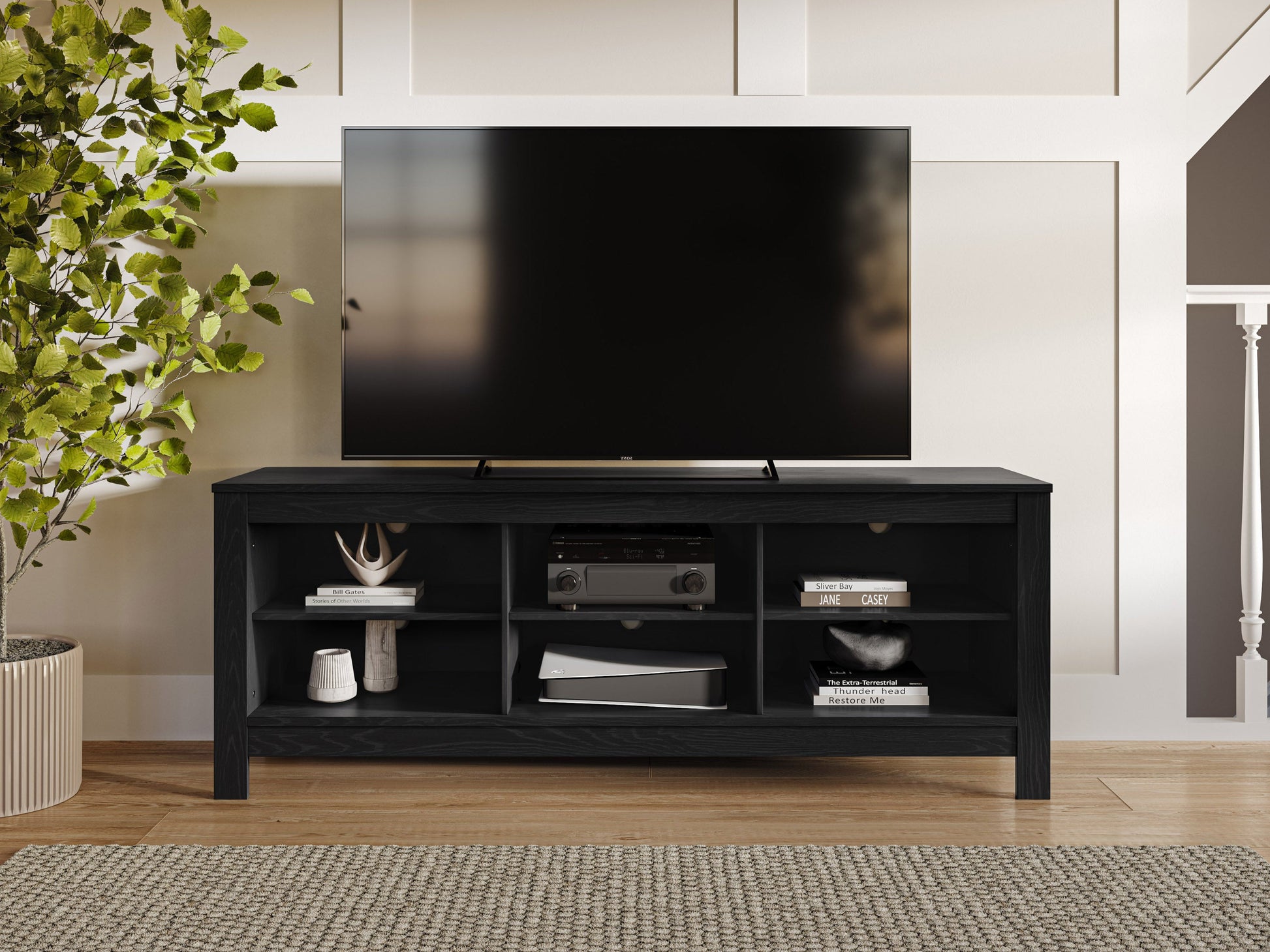 Black media console with sleek design, supports TVs up to 85 inches, features two spacious cabinets, open shelving for electronics, and cable management system. Matte black finish with modern metal handles.