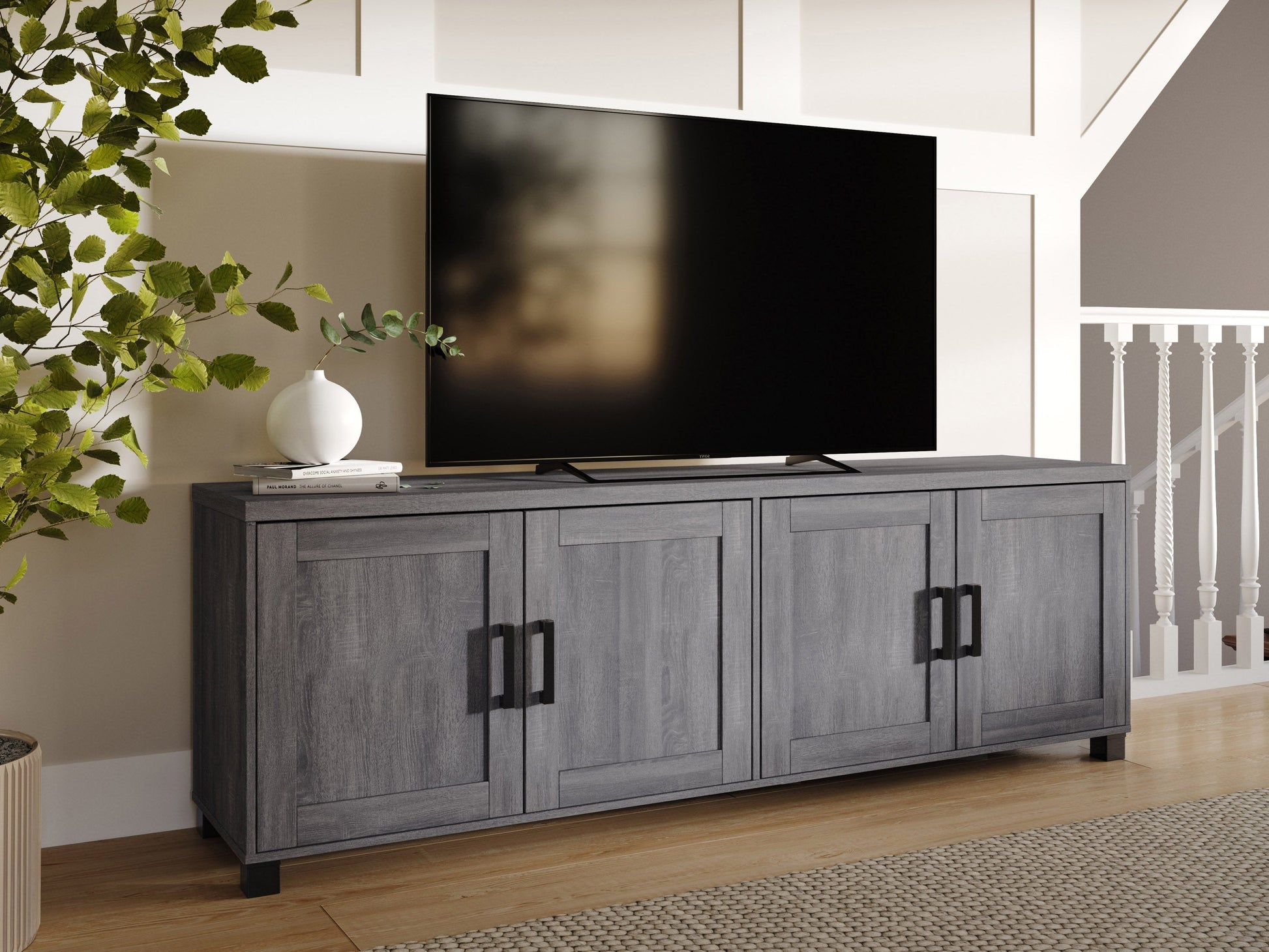 Dark grey TV stand with doors, designed for TVs up to 85 inches. Features sleek, modern design, smooth finish, and ample storage space for media devices and accessories.