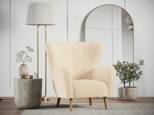 Cream Boucle Wing Accent Chair with black metal legs, featuring a textured fabric, curved backrest, and elegant design, perfect for modern living rooms or bedrooms.