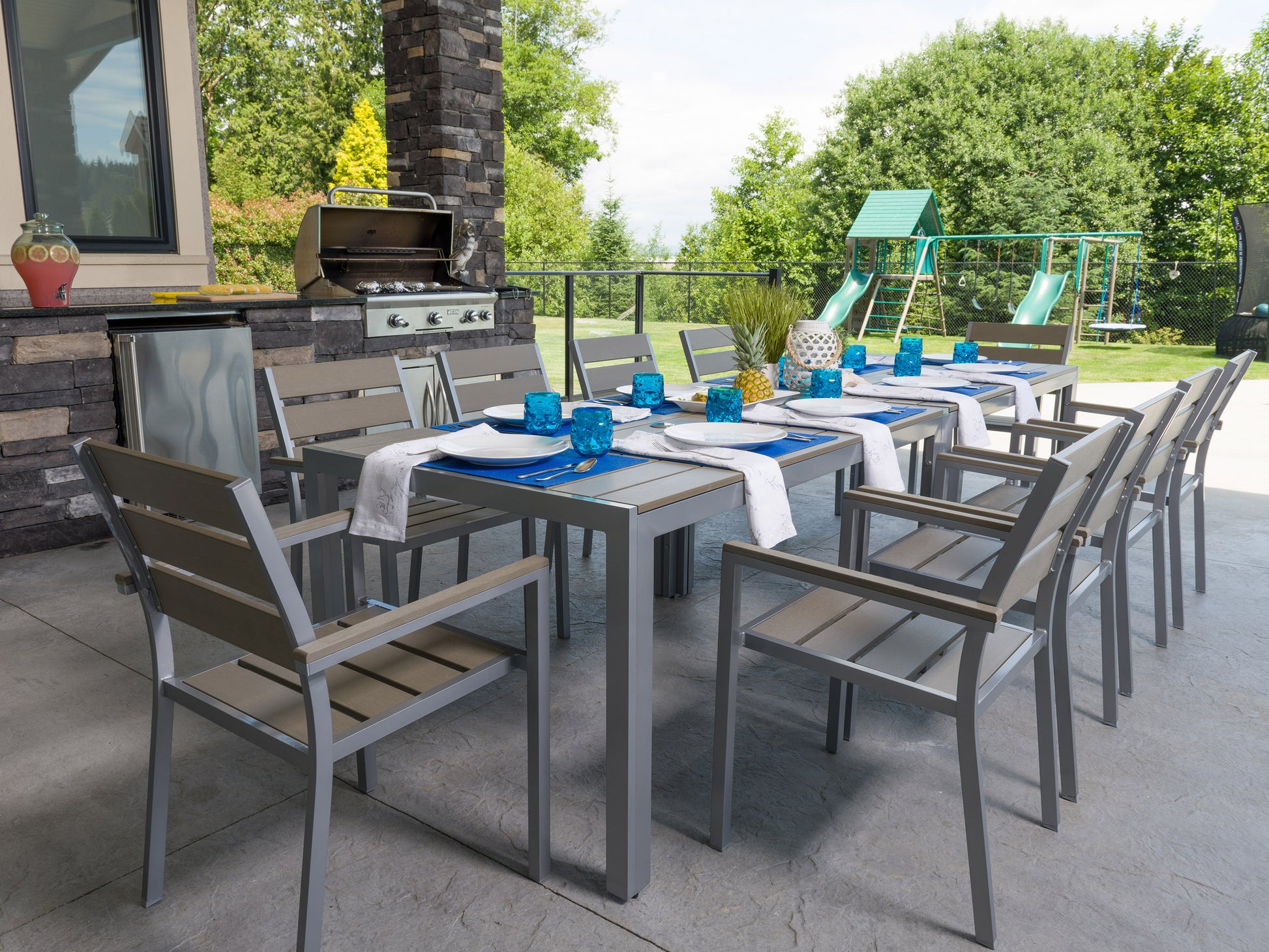 Outdoor dining set with six cushioned chairs and a rectangular table, featuring a sleek black metal frame and beige cushions, perfect for patio or garden use.