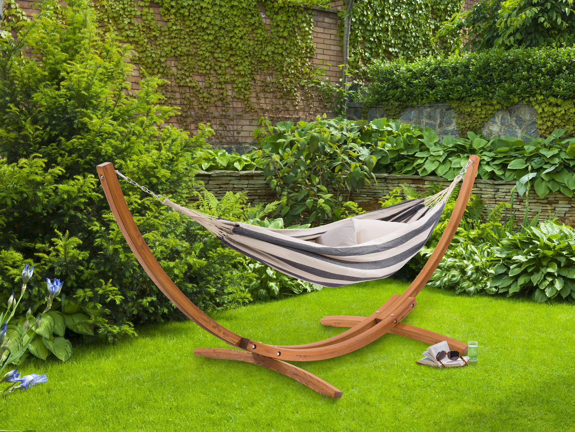 Wooden stand hammock with beige fabric, featuring sturdy wooden frame and comfortable canvas material, perfect for outdoor relaxation in patios or gardens.